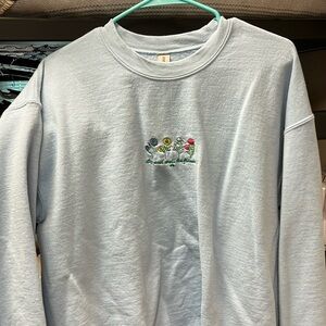 Light blue Nature Backs stop and smell the flowers sweatshirt